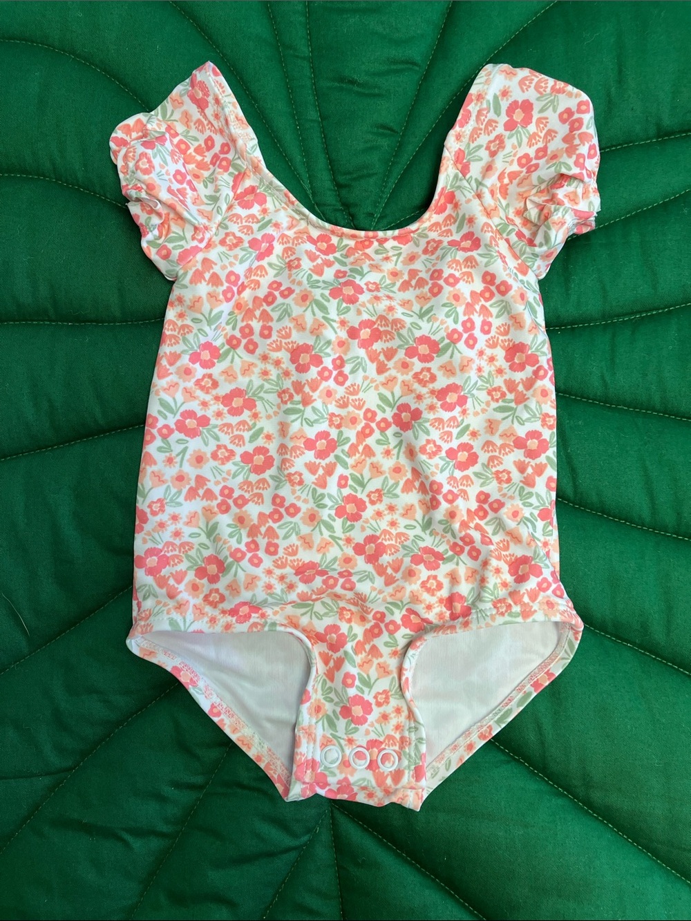 NWOT Carter’s girls peach, pink, green floral one piece swimsuit. Size 9mos.